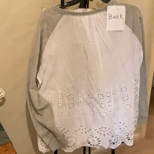 Super cute top. The back is white eyelet.